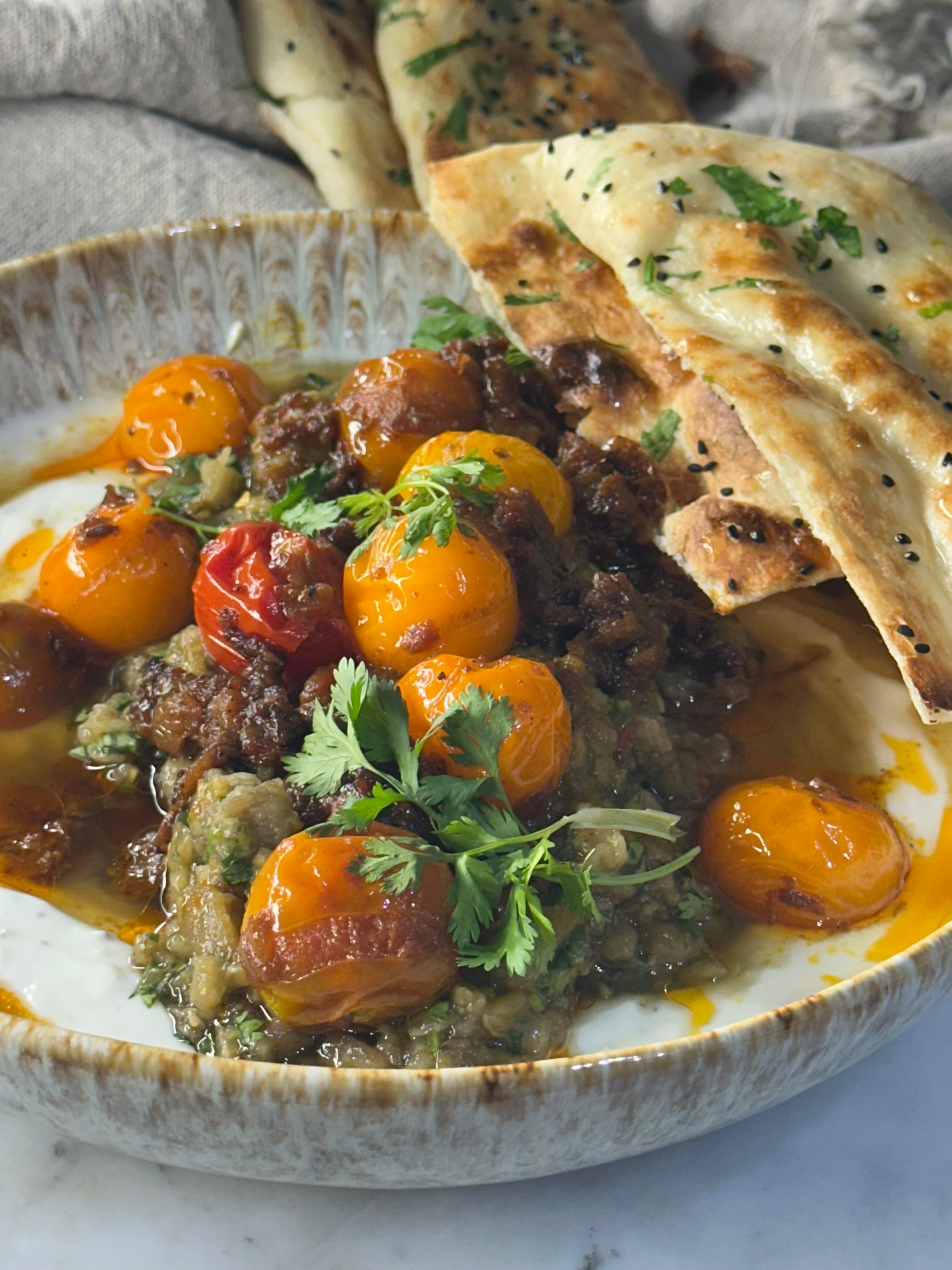 Bhartha with style ! Roasted Eggplant with Garlic Raita and cherry tomatoes